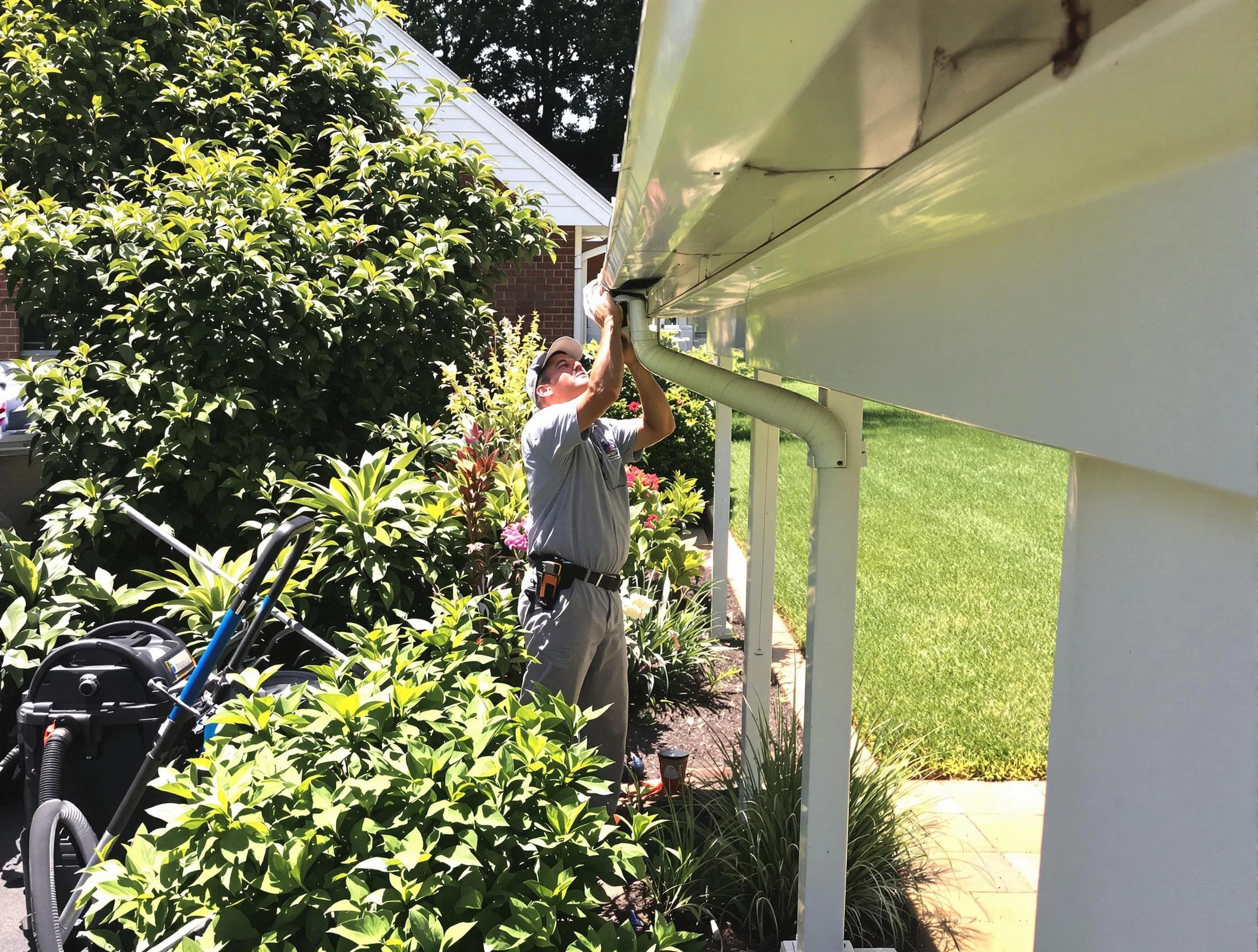 Technician flushing a blockage from a downspout in Willowick, OH